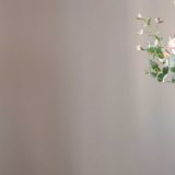 A woman holds in her hand a festive flower arrangement with bright chrysanthemum flowers, a festive bouquet. Web, social media banner template. Copy space.